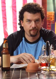 a man sitting at a table with food in front of him