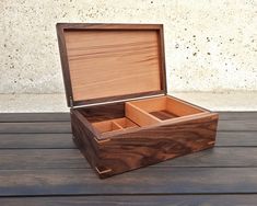 an open wooden box sitting on top of a wooden table