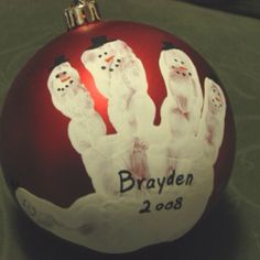 a red ornament with three snowmen on it and the name brayden