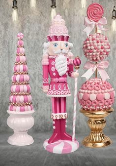 three pink and gold nutcrackers are on display