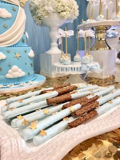 blue and white desserts on a table with gold confetti, stars and clouds