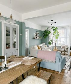 a living room filled with furniture and a wooden table