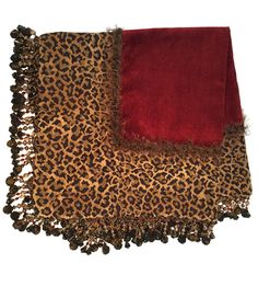 two pieces of animal print fabric with red and brown accents on top of each other