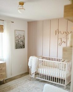 a baby's room with a crib and dresser