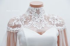 Handmade romantic lace bridal cape by yours truly. This bridal cape can be worn as many styles as you wish Color : Light Ivory Details: High collar Cape length 50cm/ 20in Back closing with button Materials :tulle, Rhinestone, crystal, pearl Standard size: Neck: 32-35cm Shoulder:36-40cm Bigger size (10 Neck: 36-41cm Shoulder: 41-45cm Shop other BRIDAL CAPES here : http://etsy.me/2zd6PZj Turnaround time: Due to the delicate nature of the handcrafted goods we produce this cover up has creation time Elegant White Capelet For Wedding, Fitted Capelet With Cape Sleeves For Wedding, Lace Wedding Cape, Wedding Dress Capelet, Wedding Bodysuit, Bridal Capes, Bridal Bodysuit, Bridal Capelet, Cape Wedding Dress