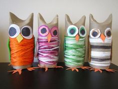 three owls made out of yarn sitting next to each other on top of a table