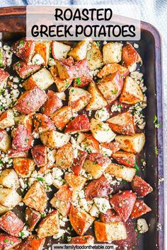 roasted greek potatoes with feta cheese and parsley in a baking dish on a blue towel