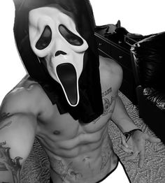 a shirtless man with a mask on his face and tongue sticking out from underneath