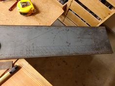 a large metal saw sitting on top of a wooden table