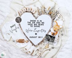 a baby announcement is displayed in the shape of a heart with pictures and words on it