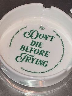 a white frisbee with the words don't die before trying on it