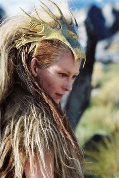 a woman with long hair wearing a costume