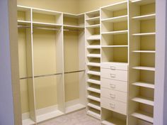 an empty walk in closet with shelves and drawers