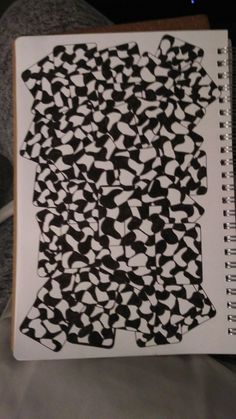 a notebook with black and white designs on it