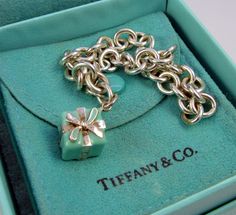 Authentic Tiffany & Co Gorgeous Sterling Silver Tiffany Blue Gift Box Charm Bracelet. The attention to detail is amazing! This elegant bracelet is in excellent condition.  It is 100% authentic. Fully engraved:   T & CO  925 on the bottom of the charm and it is engraved 925 on the lobster clasp.  It measures 7.5 inches long and weighs a very substantial 22.6 grams. It lays on the wrist beautifully. Sure to be treasured. It comes in it's Tiffany pouch and box. From a wonderful collection of fine jewelry. Please visit my ebay tsore for unique estate jewelry. Thank you. Vintage Tiffany, The Lobster, Blue Gift, Elegant Bracelet, Fine Jewelry Bracelets, Tiffany And Co, Tiffany Blue, Estate Jewelry, Tiffany & Co.