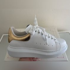 Brand New Never Worn Women’s Metallic Gold With With Oversized Alexander Mcqueen Sneakers Size 38. Comes With Box And Dust Bag. $500 Obo Custom Leather Sneakers With Contrasting Heel Counter, Luxury Gold Custom Sneakers With Round Toe, Chic Gold Leather Sneakers, Luxury White Custom Sneakers, Designer Custom Sneakers With White Sole, Chic White Platform Sneakers, Alexander Mcqueen Sneakers Red, Alexander Mcqueen Sneakers Outfit, Alexander Mcqueen Sneakers Black