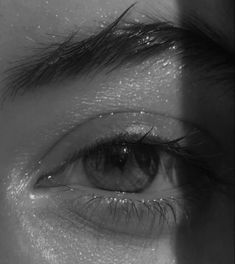 black and white photograph of someone's eye looking in the opposite direction to their left side