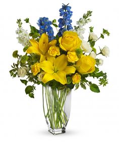 a vase filled with yellow and blue flowers