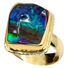 Art jewelry is as unique as its collectors. This boulder opal not only has the blue, green & red flashes that everyone loves, but it has a unique quality of a pyramid stone. Meaning, that instead of a flat surface it undulates much like a pyramid. The opal is wrapped in 22k gold and the band is 18k gold. Its rim has been textured giving it yet another unique character. Love this ring! Size 7.75 Luxury Unique Green Opal Ring, Luxury Gold Opal Ring With Cabochon, Luxury Green Cabochon Opal Ring, Opal Cuff Bracelet, Opal Bangle, Luxury Multi-stone Opal Ring In 14k Gold, Luxury Multicolor Opal Cabochon Ring, 22k Gold Ring, Boulder Opal Necklace