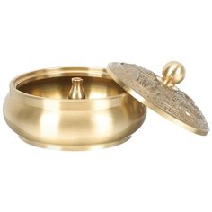 an empty brass bowl with a lid on a white background