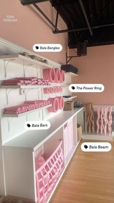 the shelves have pink items on them and are labeled with their names in different languages