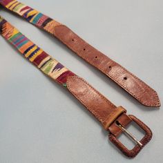 Cute striped hippie boho belt Material leather and cotton Condition : some wear and cracking Adjustable metal buckle Measurements Lying Flat End to end length: 36" Width: 1.25" Bohemian Antique Belt Buckles For Festivals, Artisan Multicolor Fabric Belt, Bohemian Adjustable Belt With Antique Buckle, Adjustable Artisan Multicolor Belt, Adjustable Bohemian Belt With Antique Buckle, Adjustable Multicolor Bohemian Belts, Handmade Leather Bohemian Belts, Bohemian Brown Belt Buckles For Festival, Handmade Bohemian Leather Belts