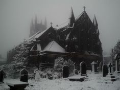 a black and white photo of a church in the snow