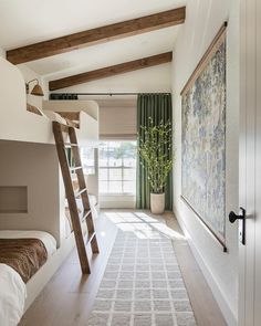 a bedroom with bunk beds and a ladder leading to the top bed in the room