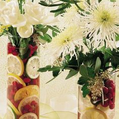 two vases filled with different types of fruit and flowers