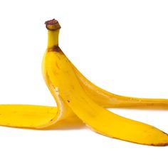 three ripe bananas sitting next to each other on a white surface