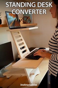 a woman standing in front of a computer desk with a keyboard and monitor on it