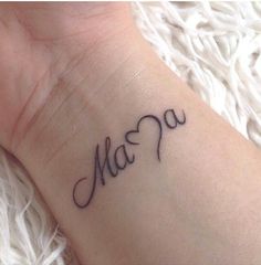 a tattoo with the word mama written in cursive writing on it's wrist