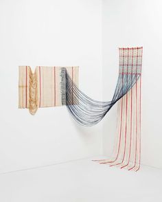 two weavings are hanging on the wall next to each other in an art gallery