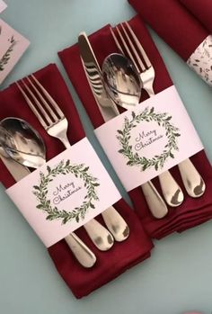 silverware on red napkins and place cards for guests to sit at the table