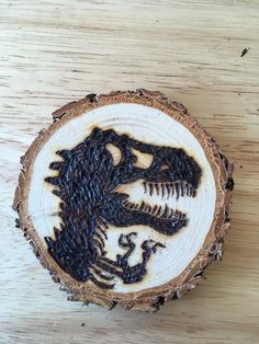 a piece of wood with an image of a dinosaur on it