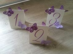 three purple butterflies on white cards with the number twenty one and two are placed next to each other