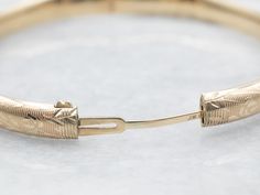 The details on this vintage 14-karat gold bangle are simply stunning! Intricate scrolling botanical designs are engraved in warm yellow gold, covering the entire bracelet. Beautiful on its own or layered with other bracelets this piece is perfect for day or evening wear.Metal: 14K Yellow GoldWidth: 6.3 mmInside Circumference: 6 1/2 InchesMarks: "JW 14K" Stamped on the inside band Classic 14k Gold Bracelets With Intricate Design, Classic 14k Gold Bracelet With Intricate Design, 14k Gold Bracelets With Intricate Design For Anniversary, Anniversary 14k Gold Bracelets With Intricate Design, Classic Gold Bangle Bracelet With Intricate Design, Heirloom Gold Bangle Bracelet With Intricate Design, Classic Gold Bangle With Intricate Design, Classic Yellow Gold Filigree Bracelet, 14k Gold Bangle Bracelet With Intricate Design