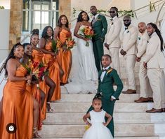 the bride and grooms are posing on the stairs with their bridal party in orange dresses