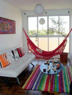 a living room filled with furniture and a hammock