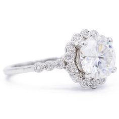 a white gold ring with an oval cut diamond surrounded by small round diamonds and pave set in the shan shan shan shan shan shan shan shan shan shan shan shan shan shan shan shan