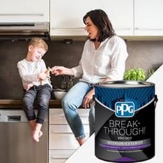 a woman and child are sitting on the kitchen counter next to a can of break through