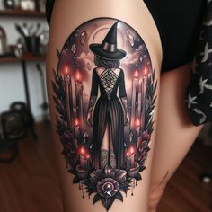 a woman's thigh with an image of a witch in the center and candles behind her