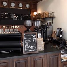 a coffee shop with lots of different types of items on the counter and menu board