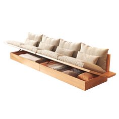 a couch that is sitting on top of a wooden shelf with several pillows in it