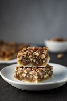 two pieces of pecan pie bars on a white plate with the title above it