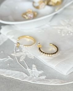 Elevate your jewelry collection with our Brielle Hoops. These stylish pearl hoop earrings are expertly crafted with gold-plated silver and adorned with faux pearls for a touch of elegance. Perfect for any occasion, these hoops add a subtle yet sophisticated touch to any outfit. Paris Wedding, Pearl Hoop Earrings, Gold Plated Silver, Parisian Style, Pearl Jewelry, Faux Pearl, Gold Earrings, Jewelry Collection, Pearl Earrings