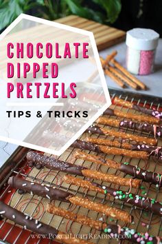 chocolate dipped pretzels on a baking sheet with sprinkles in the background