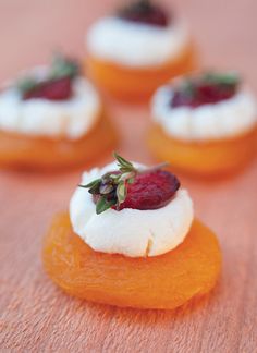 small pastries with cream and fruit on top