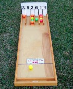 an image of a wooden board game with balls on the side and numbers on the back