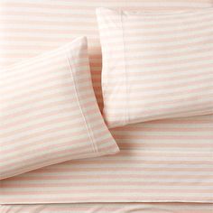 two pillow cases with pink and white striped sheets